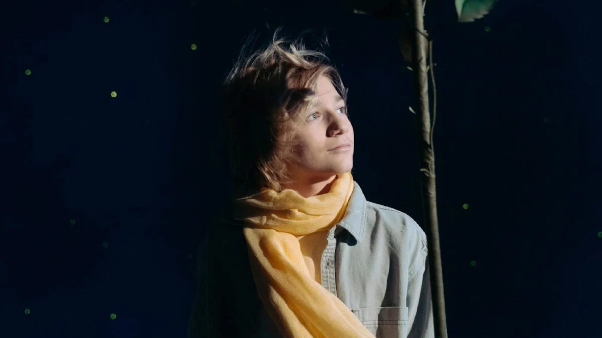 boy-with-yellow-scarf-holding-a-red-flower-7182065